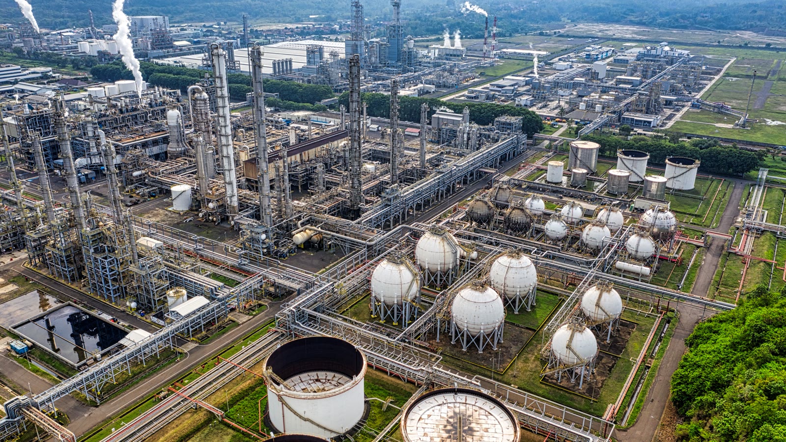 Illustrative aerial view of an Asian refinery and coastal industrial plant.