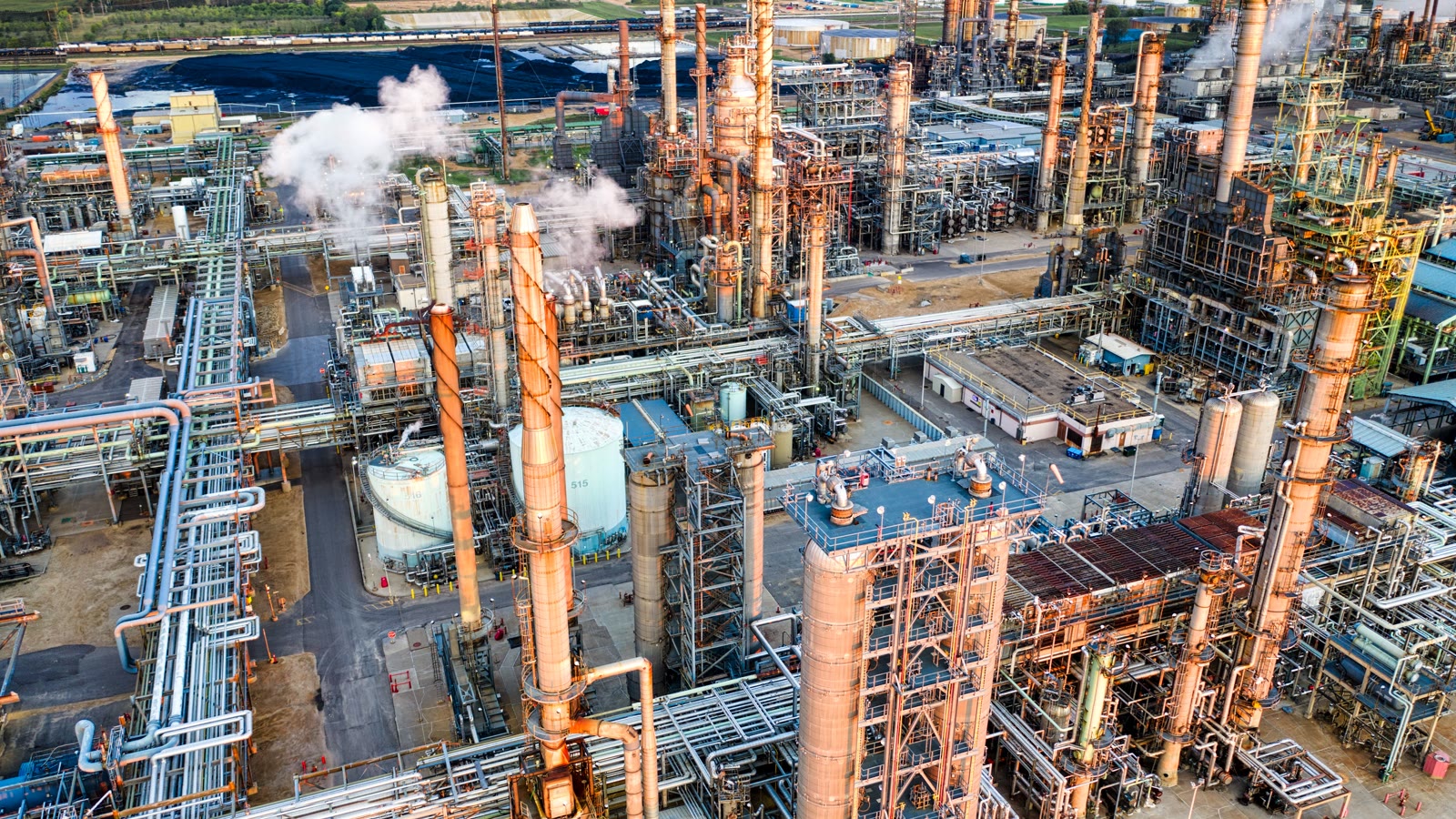 Illustrative aerial view of a large North American refinery and industrial infrastructure.