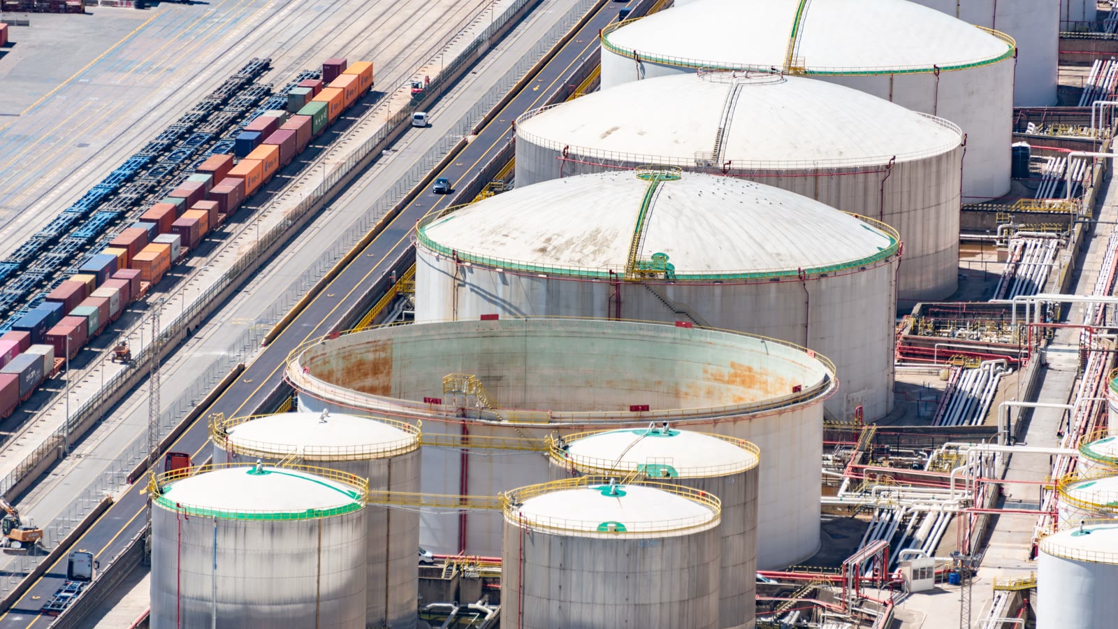 Illustrative aerial view of storage tanks, rail tracks and industrial distribution infrastructure.
