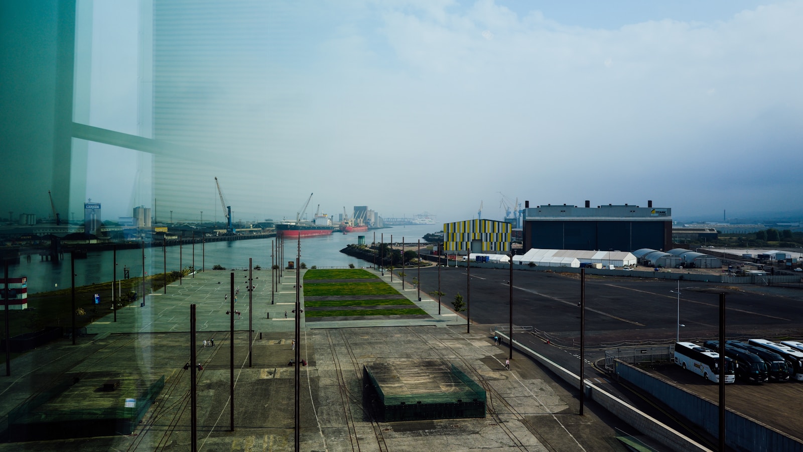 Illustrative view of a large ship and cranes at an industrial port.